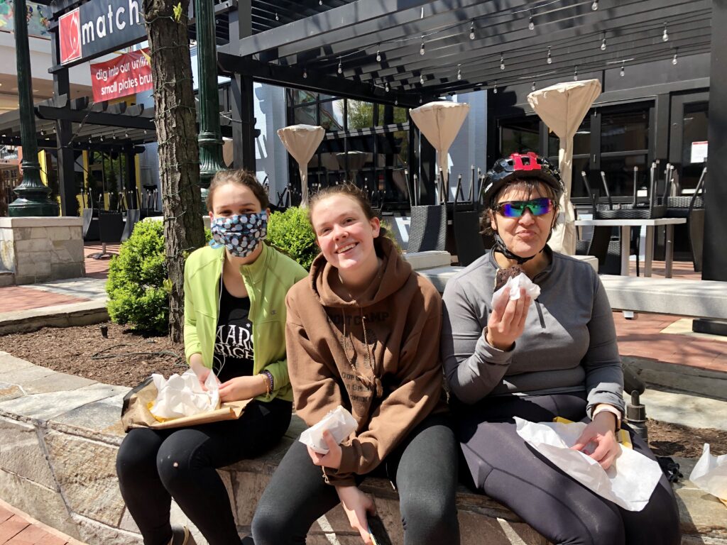 A group of people sitting on a bench

Description automatically generated